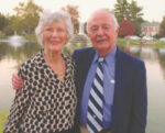 Carolyn and Dr. George Smith stand in front of Culler Lake in Baker Park smiling