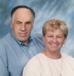 man and a woman sit smiling at the camera