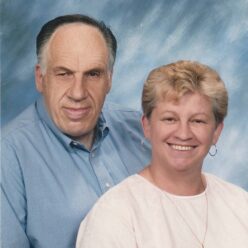 man and a woman sit smiling at the camera
