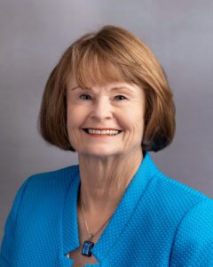 Headshot of a woman smiling at the camera.