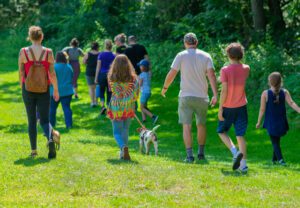 Families outdoor walking in grass