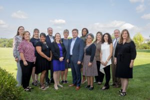 A group of professionals pose for an outdoor photo.