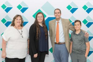 2 women, 1 man, and 1 boy posing for photo