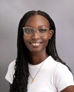 young girl with glasses and long black hair smiling