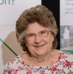 woman wearing glasses and floral shirt