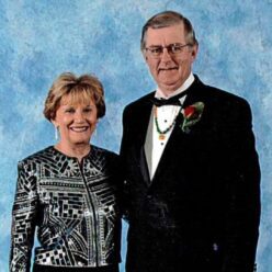 smiling woman and man dressed up in formal wear