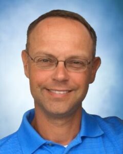 Smiling man in blue shirt