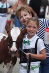 Fran Murray stands with her niece and a calf at a 4H fair event