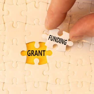 puzzle piece that says "funding" going into a puzzle opening that says "grant"