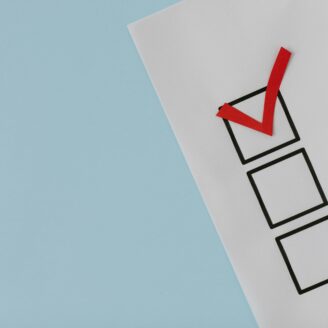 three checklist boxes with the top box checked with a red checkmark