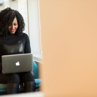 woman sits working on a laptop