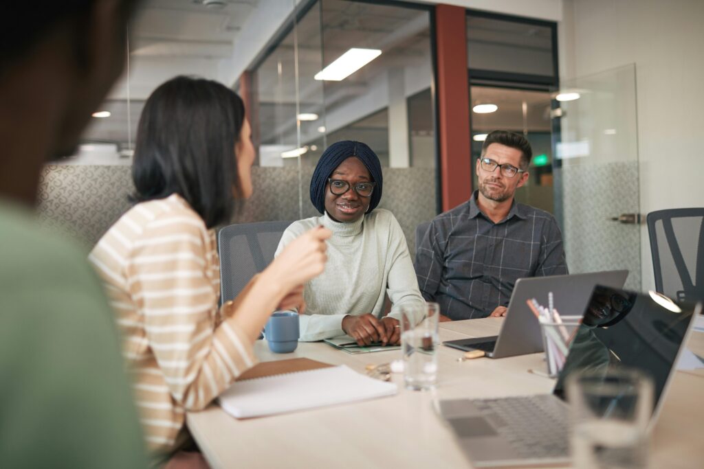 meeting with three people at a conference table