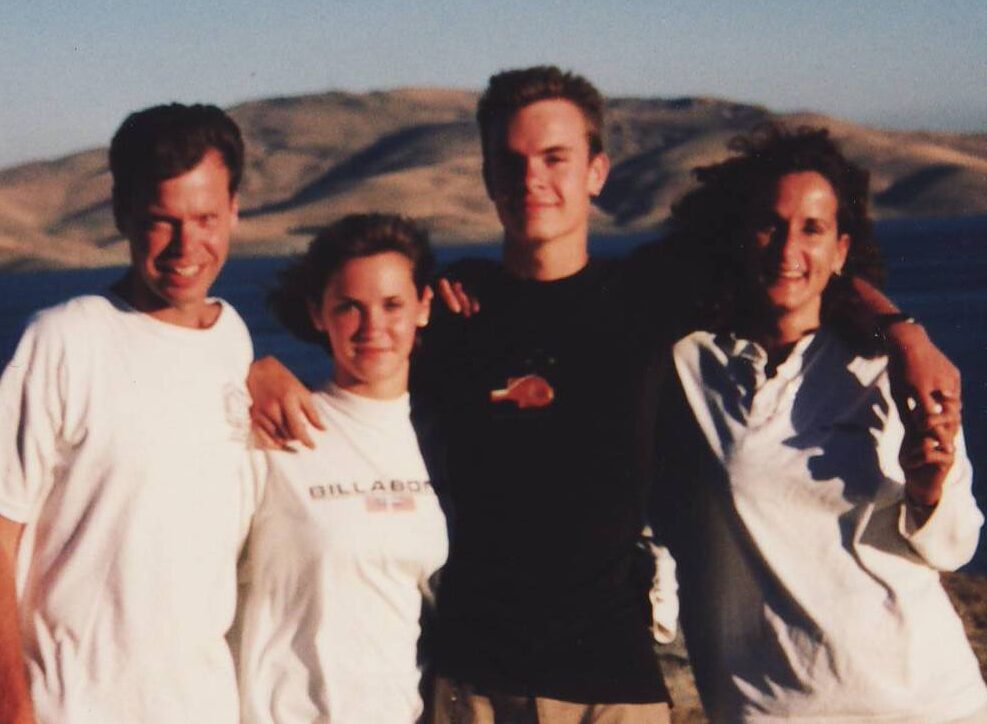Murphy family standing for a family photo at the rockies. 