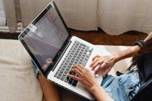 Person typing on laptop.