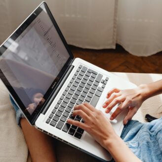 Person typing on laptop.