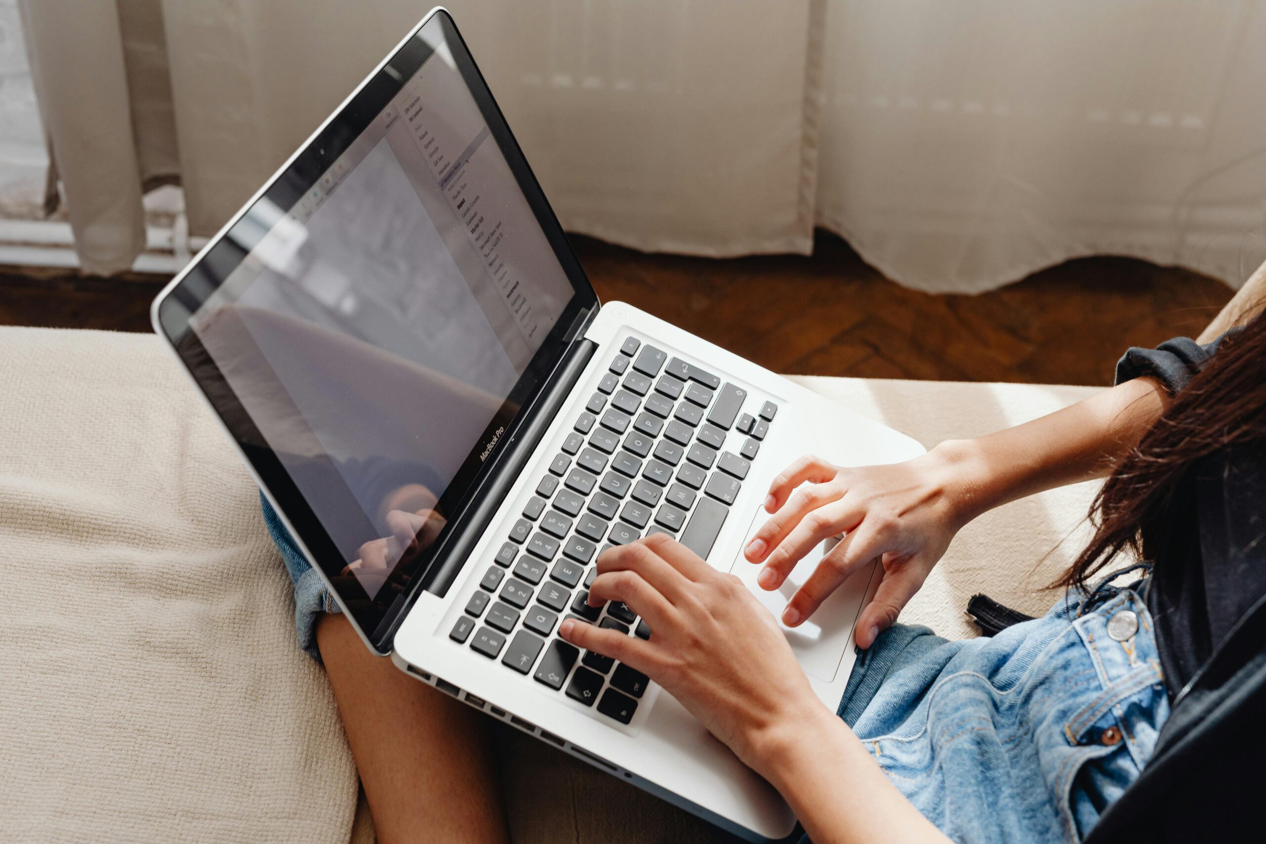 Person typing on laptop.