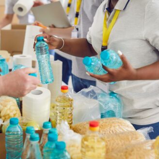 group of volunteers handle food donation items