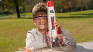 Kid holding a toy rocket.