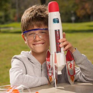 Kid holding a toy rocket.