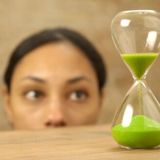 Woman watching sand timer