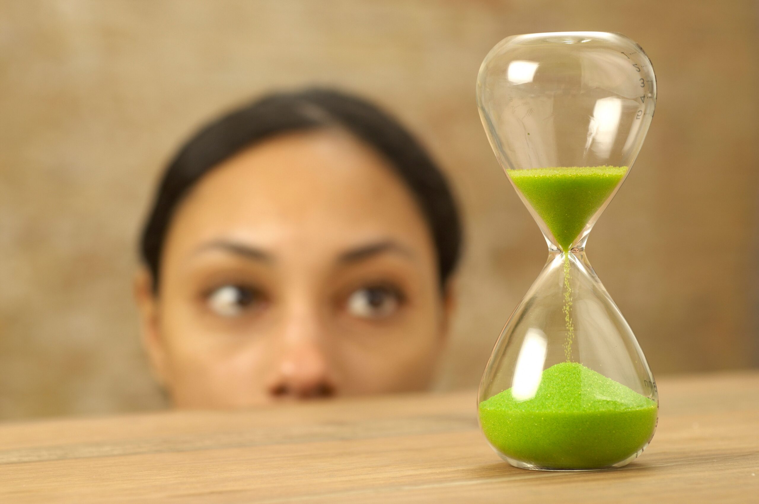 Woman watching sand timer