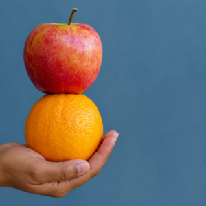 apple and orange in a hand